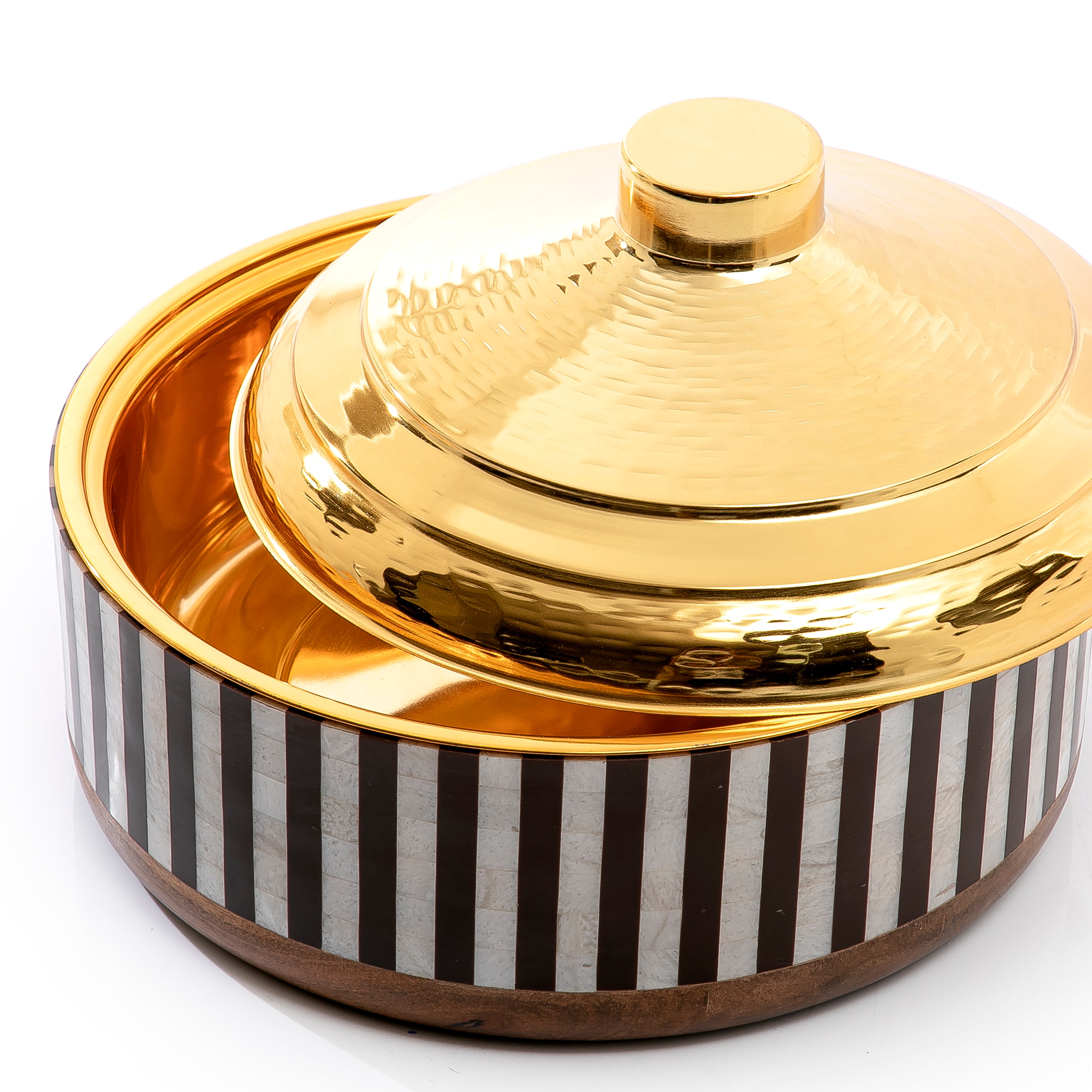 white and black round wooden food preserver with gold metal cover