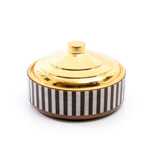 white and black round wooden food preserver with gold metal cover
