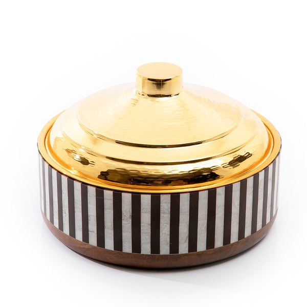 white and black round wooden food preserver with gold metal cover