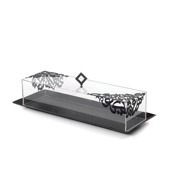 A rectangular metal tray of black colour, covered with acrylic and which is designer engraving of metal with arabic text. 50x18x10.5